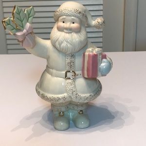 Adorable preowned Lenox Santa holding Holly figurine.